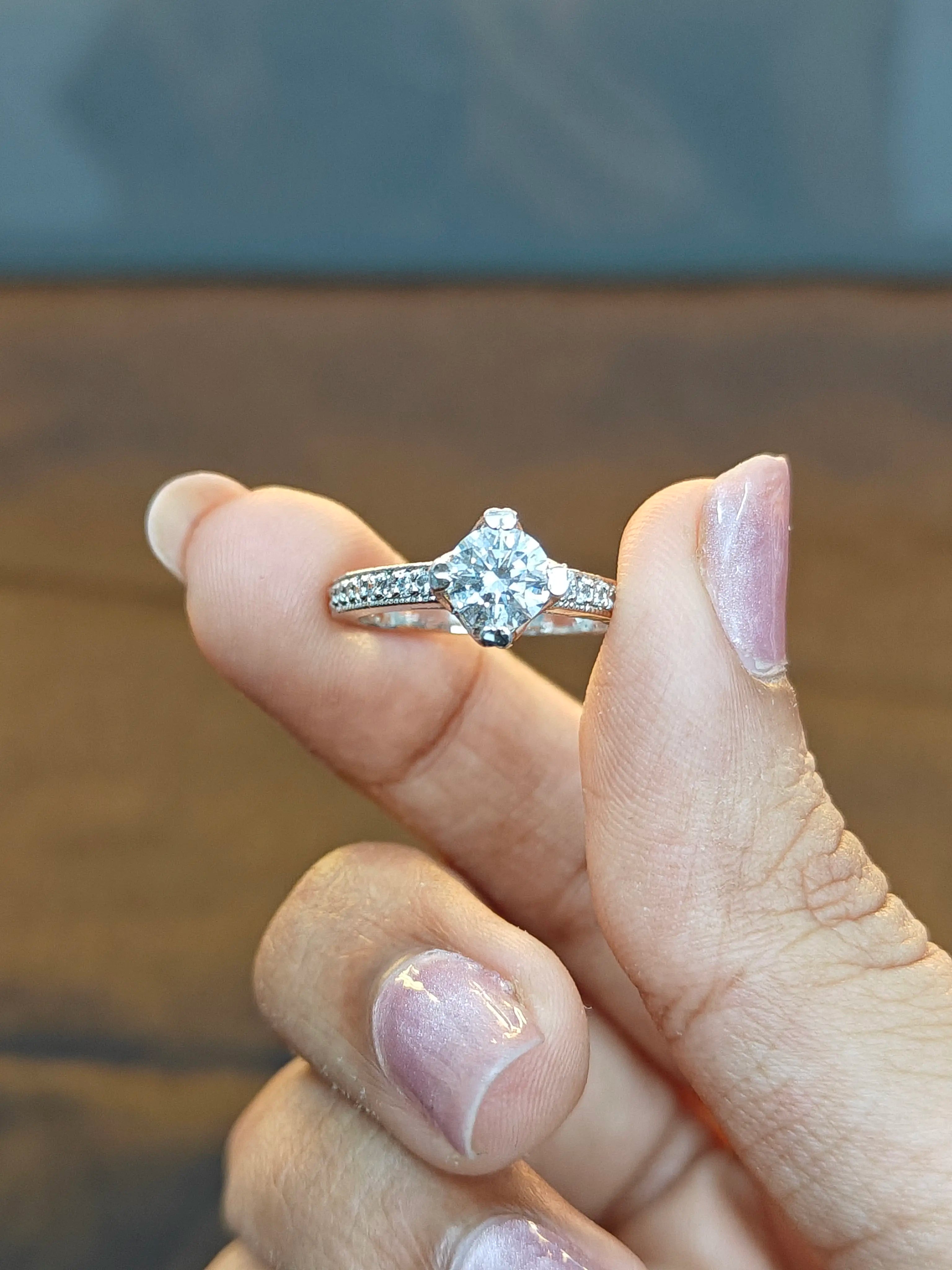 Diamond ring on a finger with a blurred background